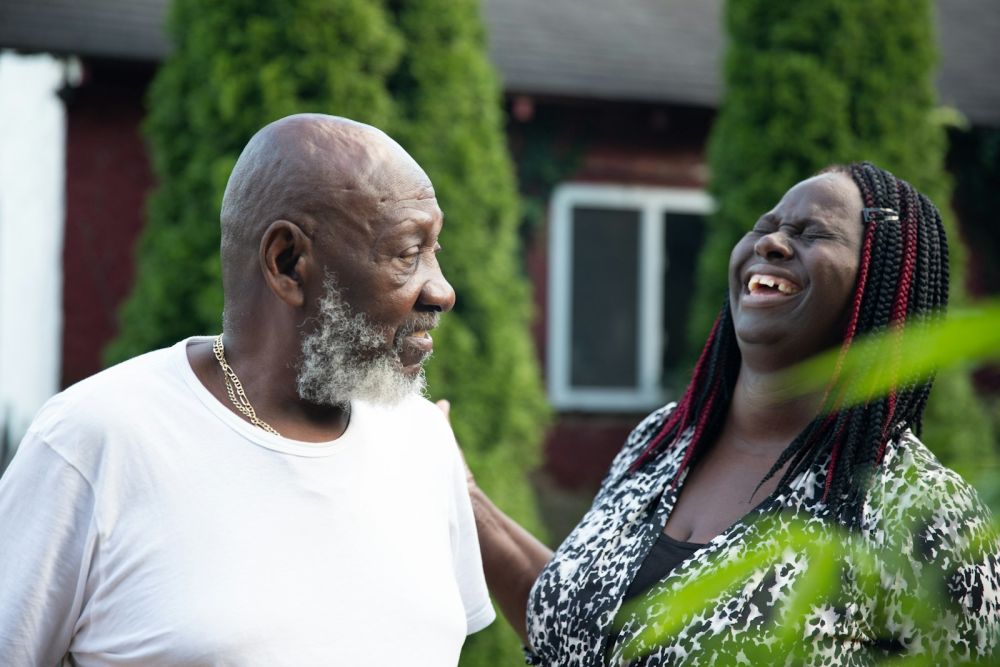 Elderly father laughing with his daughter